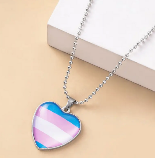 Trans pride heart pendant necklace with pink blue and white flag colors beneath glass heart charm