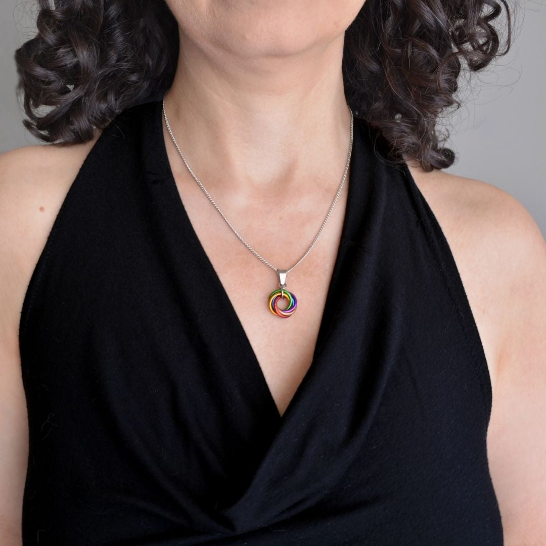 Model wearing a Pride Swirl Pendant Necklace to show necklace length and pendant size