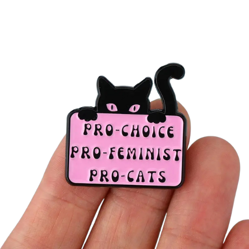 Pro-Choice Pro-Cats enamel pin featuring black cat and feminist statement artwork held by a hand