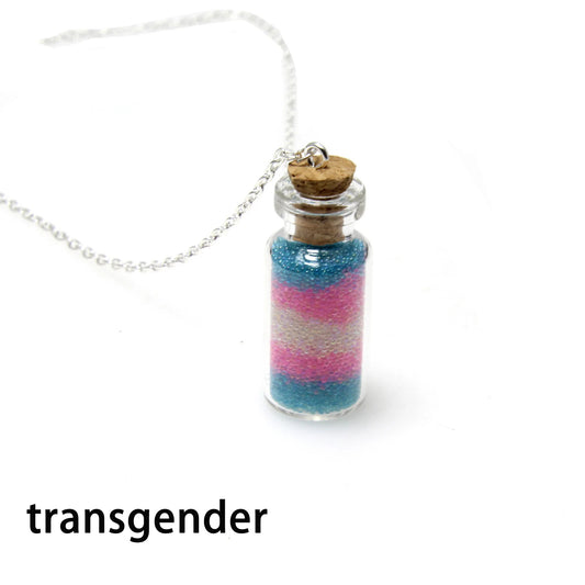 Trans pride bottle necklace with layered pink blue and white micro-beads inside tiny glass vial pendant