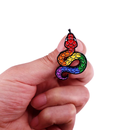 Rainbow Pride Snake enamel pin with colorful scaled serpent design held between fingers