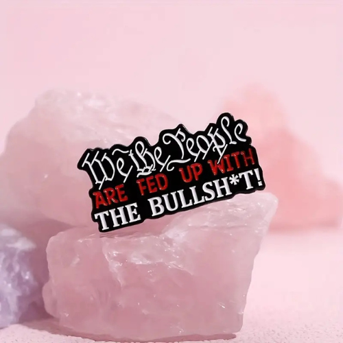 We The People Are Fed Up enamel pin with bold protest-inspired sarcastic lettering design on a pink background